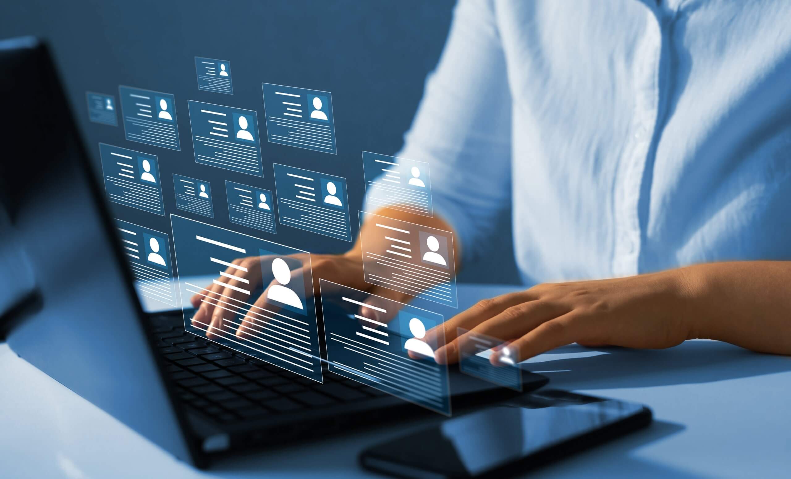 laptop with graphics of people’s applications and identities