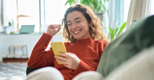 relaxed young woman sitting on couch, How to Find Social Media Accounts by Email Free