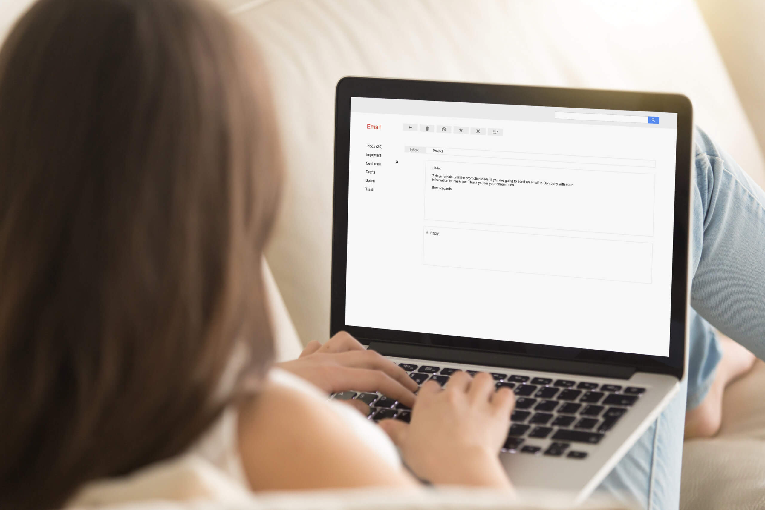 woman typing an email on a laptop