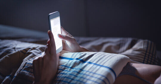person using phone late at night