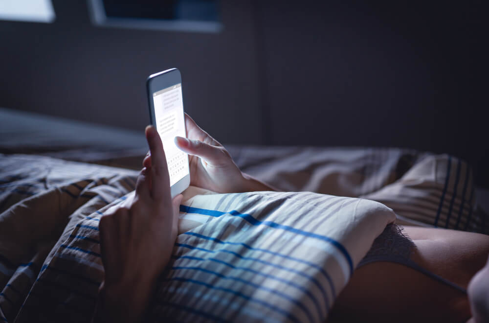 person using phone late at night