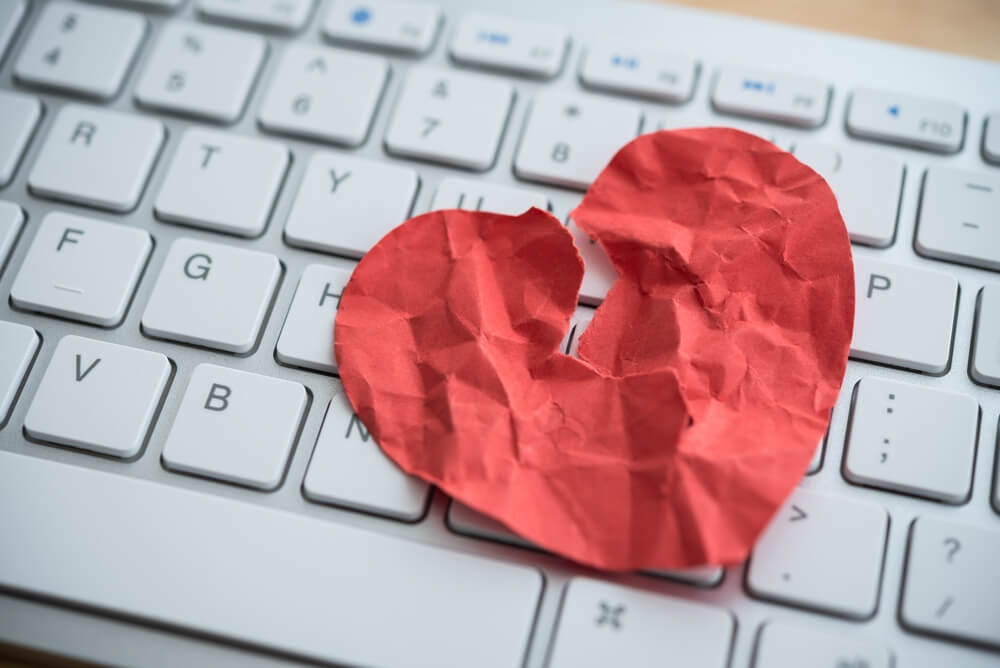 broken red heart paper on keyboard
