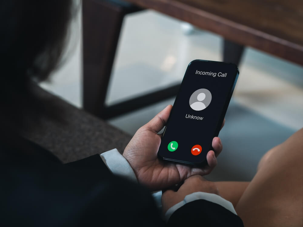 woman holding cell phone with unknown calling ringing