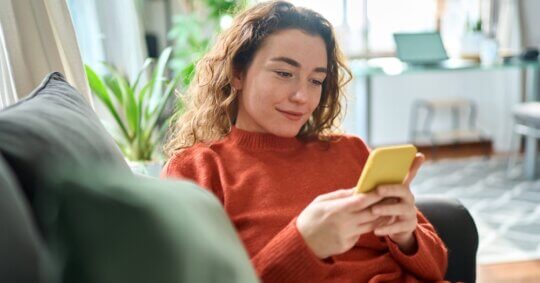 A young woman asking online dating questions on phone