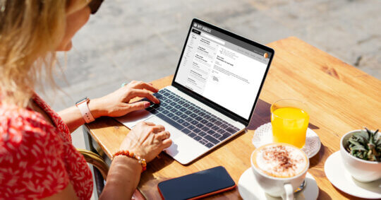 A woman performing a Gmail people search on a laptop