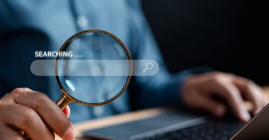 A man using his laptop to search people on OnlyFans.