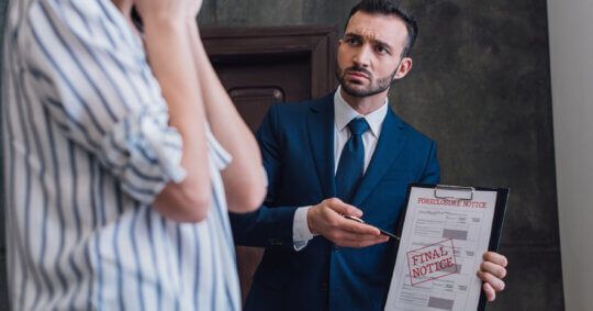 A landlord showing a tenant an eviction notice.