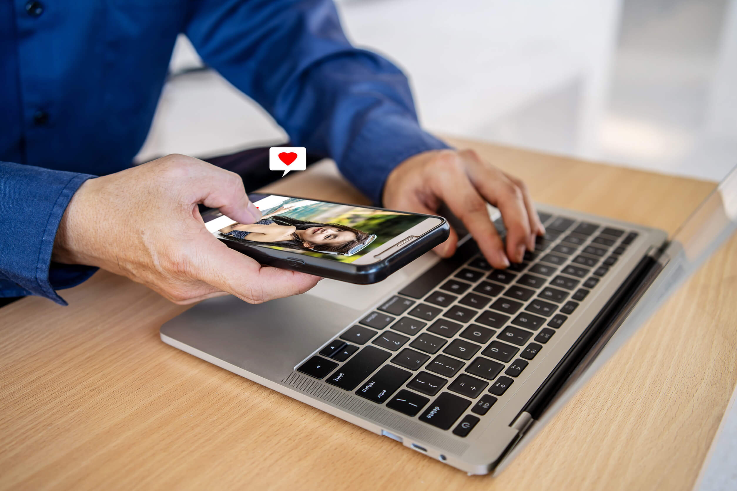A man using a laptop to research how to find if someone is on a dating site.