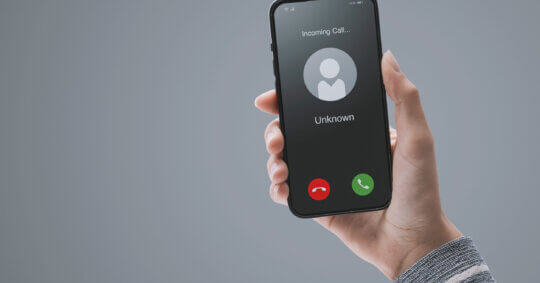 A woman getting a call from an unknown caller.