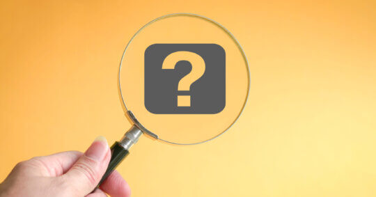 A magnifying glass examining a question mark investigating the problem of how to find info on someone.