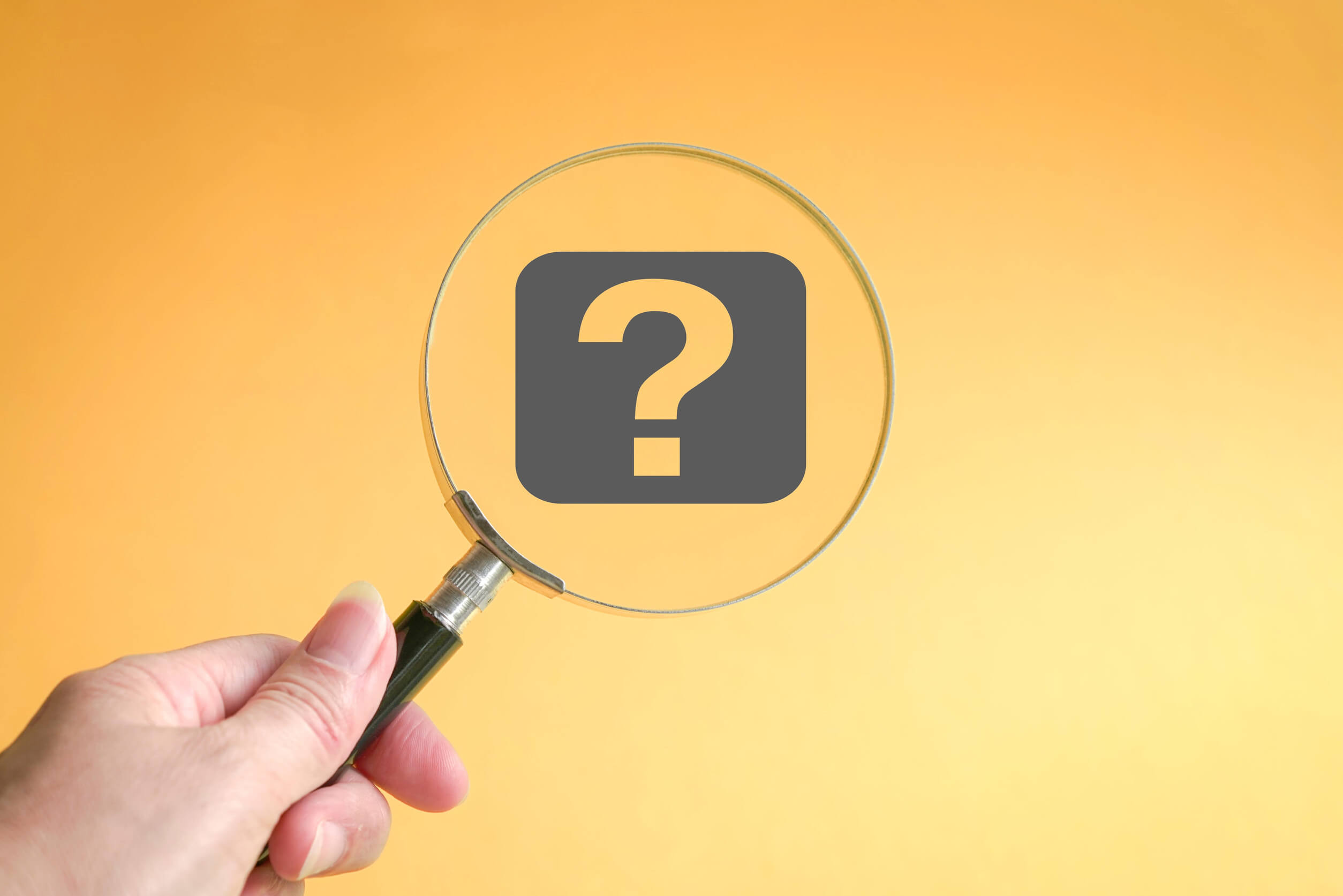 A magnifying glass examining a question mark investigating the problem of how to find info on someone.